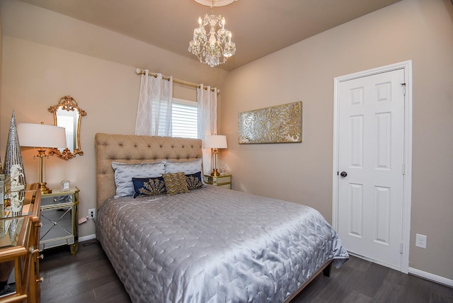 bedroom featuring a chandelier, dark wood-style flooring, and baseboards