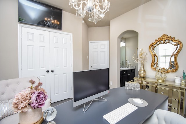 office space with a chandelier and arched walkways