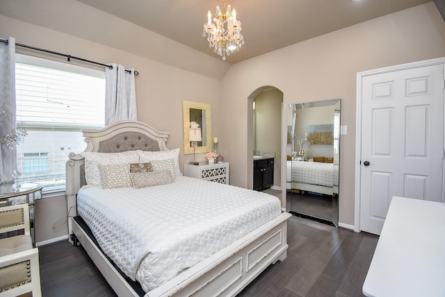 bedroom featuring arched walkways, dark wood-type flooring, a chandelier, and baseboards