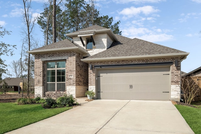 view of front of home featuring concrete driveway, stone siding, roof with shingles, an attached garage, and brick siding