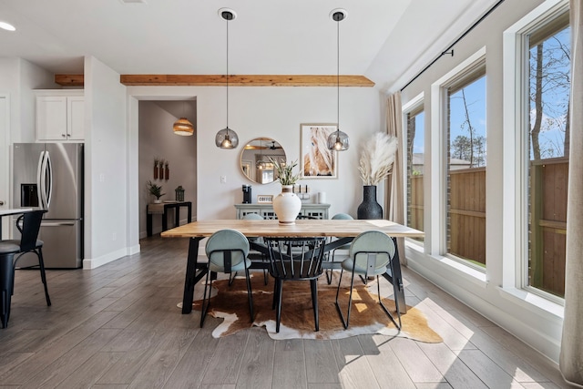 dining area with baseboards and wood finished floors