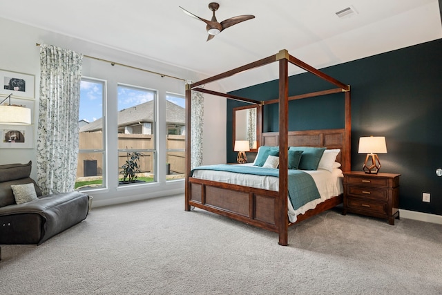 carpeted bedroom with baseboards, visible vents, and a ceiling fan