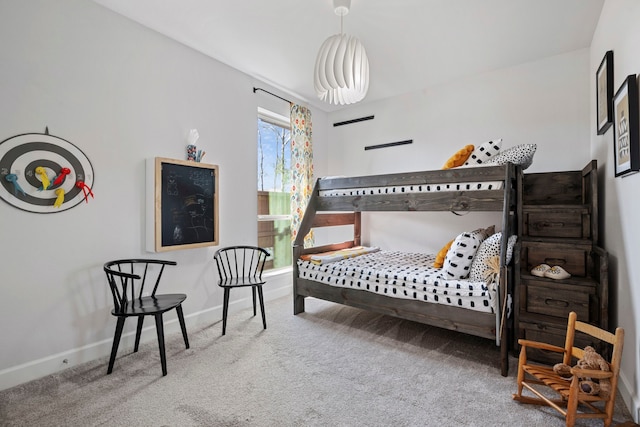 carpeted bedroom featuring baseboards