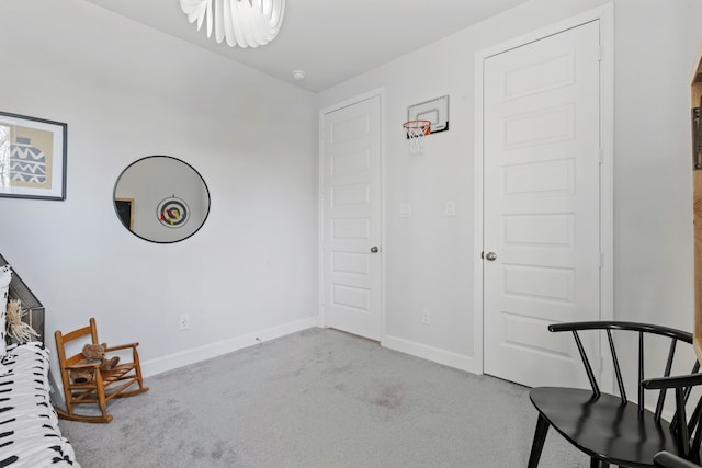 unfurnished room featuring carpet and baseboards