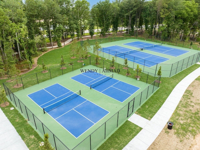 view of sport court with a yard and fence