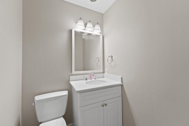 bathroom with toilet and vanity