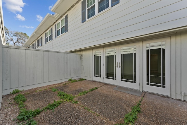 back of property with french doors, a patio area, and fence