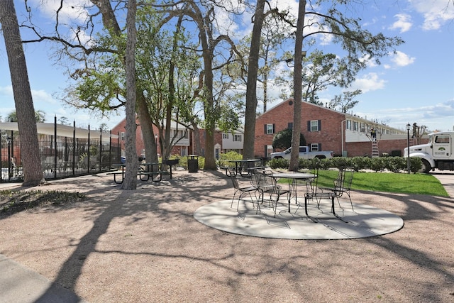 view of community with fence and a patio