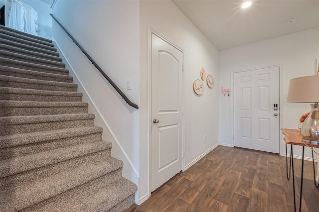 foyer entrance featuring stairway, dark wood-style floors, and baseboards