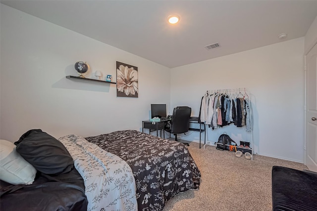 carpeted bedroom with visible vents and baseboards