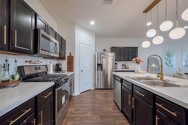 kitchen featuring a sink, light countertops, and stainless steel appliances