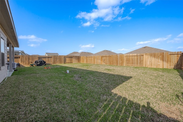 view of yard with a fenced backyard