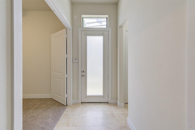 foyer featuring light tile patterned floors and baseboards