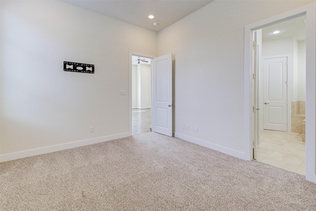 unfurnished room featuring recessed lighting, baseboards, and light carpet