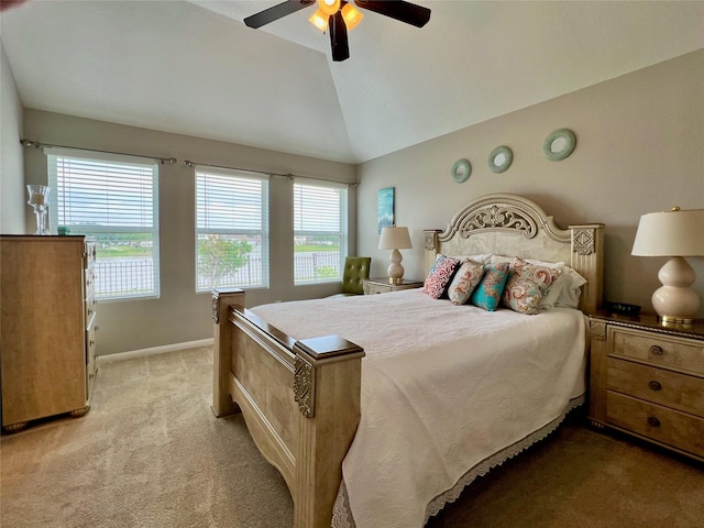 bedroom with vaulted ceiling, light carpet, a ceiling fan, and baseboards