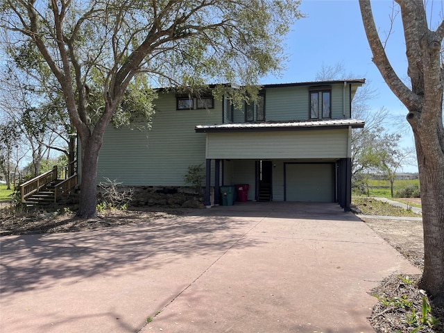 traditional home featuring a garage and concrete driveway