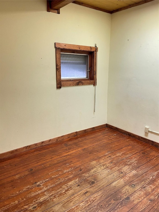 unfurnished room featuring baseboards and hardwood / wood-style flooring