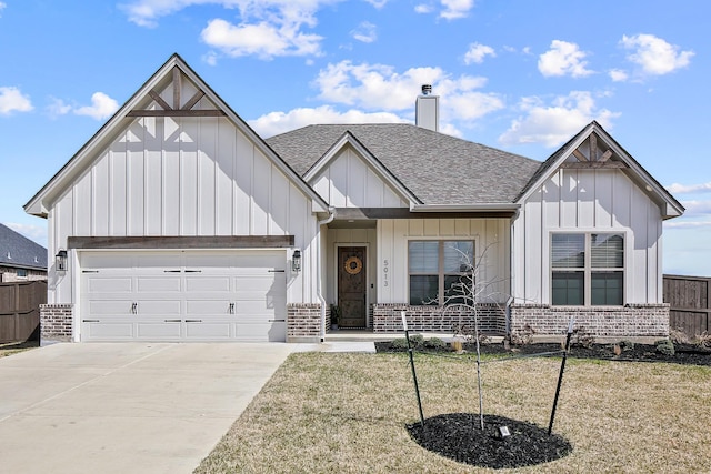 modern farmhouse featuring an attached garage, brick siding, driveway, roof with shingles, and board and batten siding