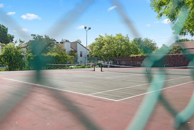 view of sport court featuring fence