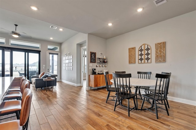 dining space featuring light wood-type flooring, visible vents, baseboards, and recessed lighting