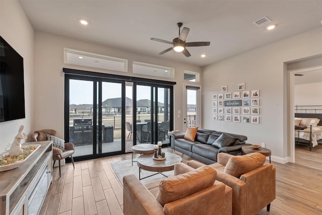 living area with recessed lighting, visible vents, a ceiling fan, and light wood finished floors