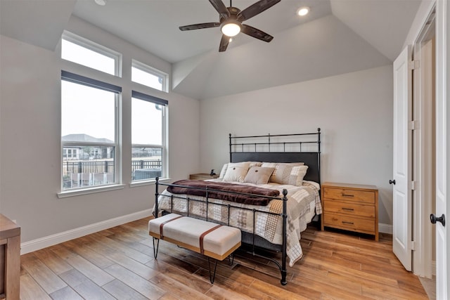 bedroom featuring ceiling fan, baseboards, lofted ceiling, and light wood-style flooring