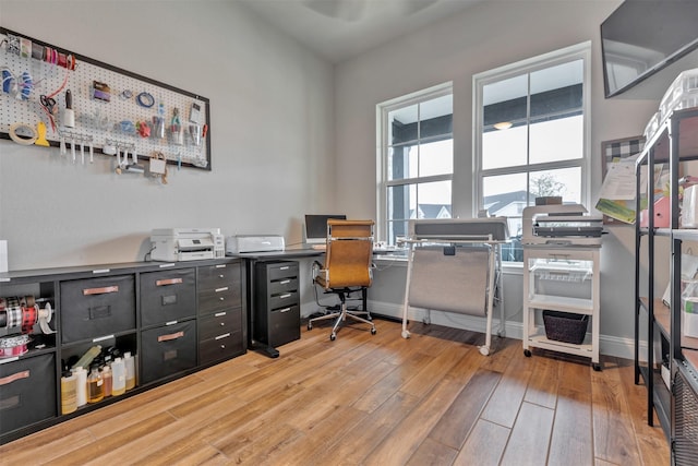 office featuring baseboards and light wood-type flooring