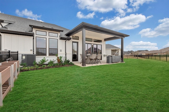 back of house featuring board and batten siding, cooling unit, a yard, a fenced backyard, and a patio