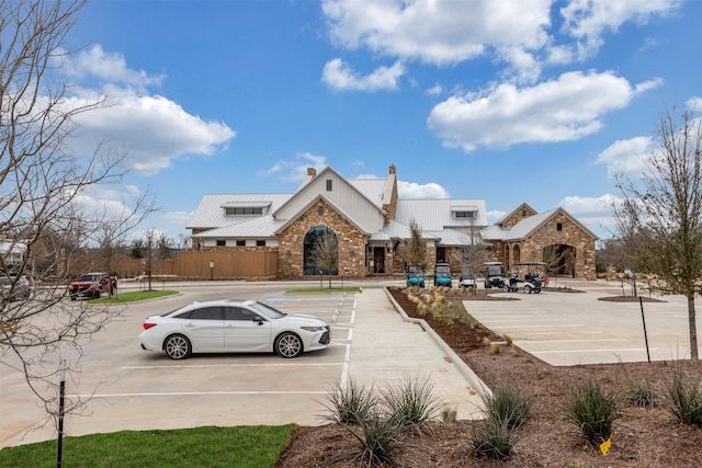 exterior space featuring uncovered parking and metal roof