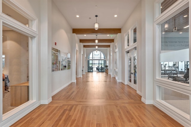 entrance foyer with beam ceiling, recessed lighting, light wood-style flooring, and baseboards