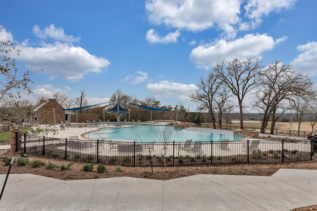 community pool featuring a patio area and fence