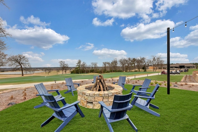 view of property's community with a lawn and an outdoor fire pit