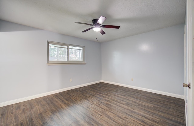 spare room with dark wood-style floors, a textured ceiling, a ceiling fan, and baseboards