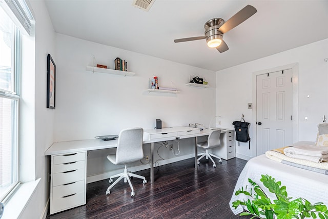 bedroom with dark wood-type flooring, a ceiling fan, visible vents, and baseboards