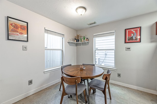 dining space with visible vents, plenty of natural light, and baseboards