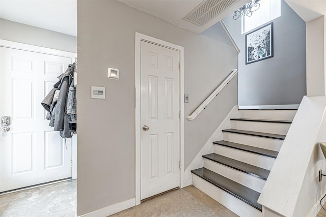 staircase with unfinished concrete flooring and visible vents