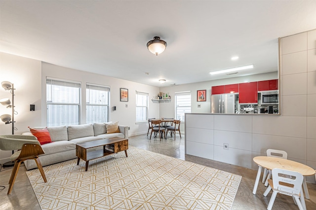 living area featuring baseboards