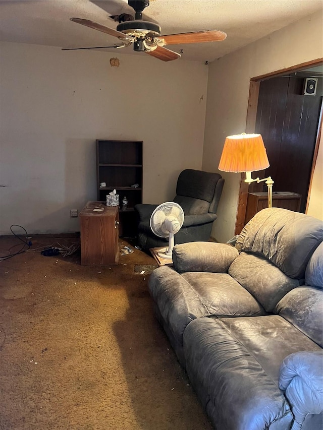 living room featuring a ceiling fan and carpet