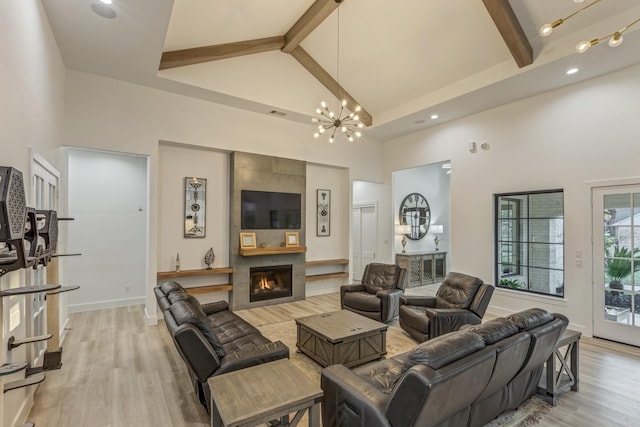 living area with beamed ceiling and high vaulted ceiling