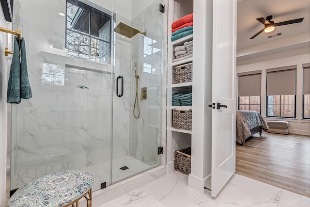 bathroom with a marble finish shower, visible vents, marble finish floor, and a ceiling fan