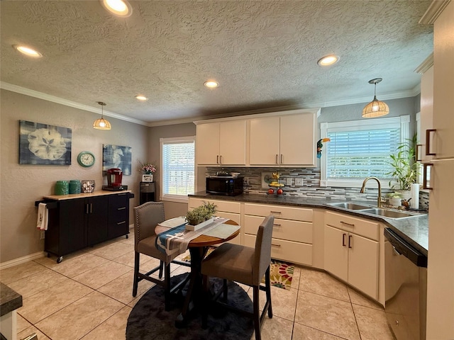 kitchen with a sink, ornamental molding, backsplash, dishwasher, and decorative light fixtures