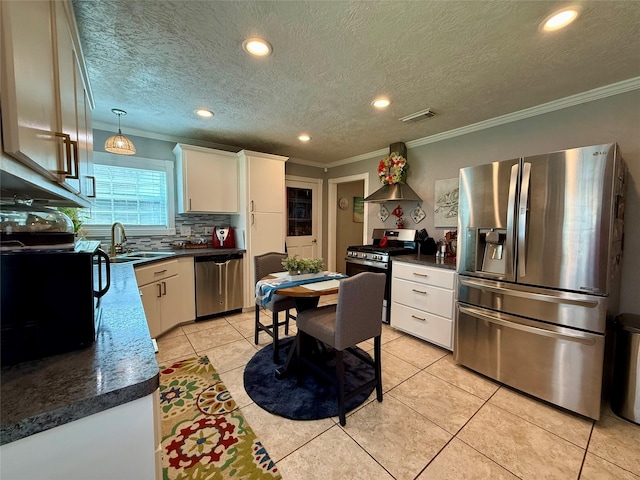 kitchen featuring stainless steel appliances, visible vents, crown molding, and wall chimney exhaust hood