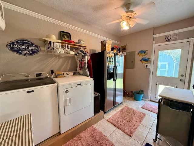 clothes washing area with electric panel, a textured wall, a textured ceiling, and washing machine and clothes dryer