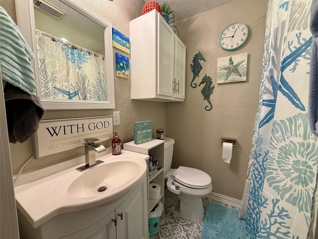 full bathroom featuring a textured wall, toilet, vanity, visible vents, and baseboards