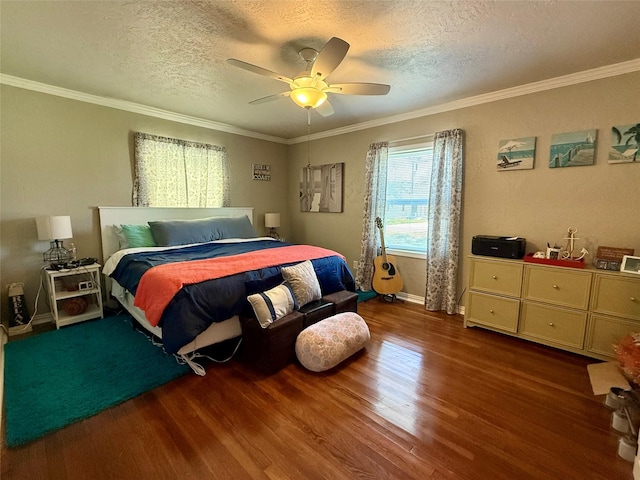 bedroom featuring a textured ceiling, ornamental molding, and wood finished floors