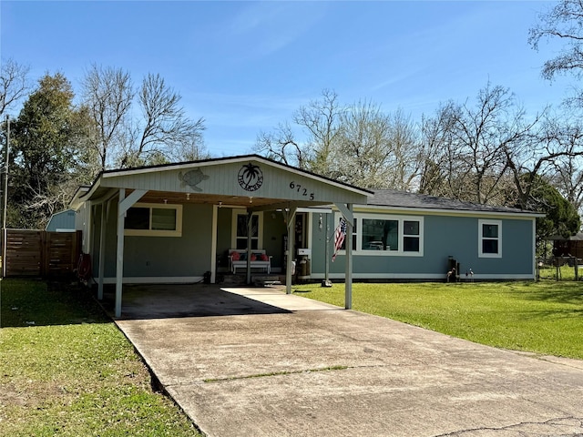 view of front of property featuring concrete driveway, fence, and a front lawn