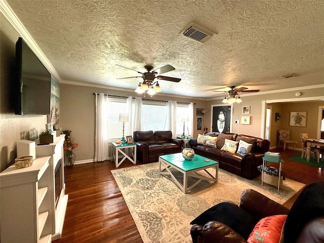 living area with dark wood-style floors, crown molding, visible vents, ceiling fan, and baseboards