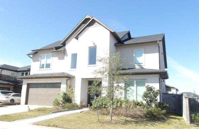 view of front of property featuring a garage, concrete driveway, fence, and stucco siding