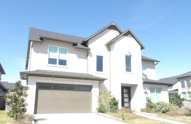 view of front facade featuring driveway, an attached garage, and stucco siding