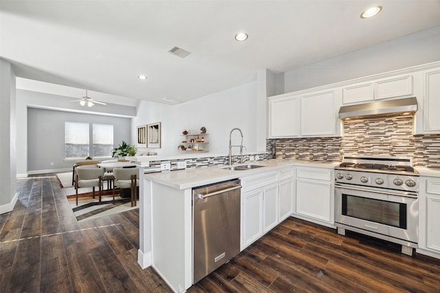 kitchen with visible vents, under cabinet range hood, appliances with stainless steel finishes, a peninsula, and a sink